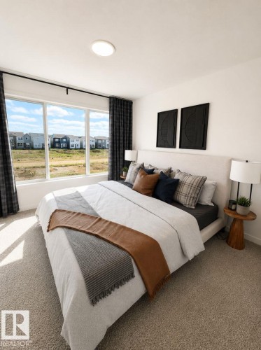 Spacious bedroom featuring broad windows, wall-to-wall carpeting, an upholstered headboard, and recessed ceiling lighting - 311 32 Street, Edmonton, AB 
