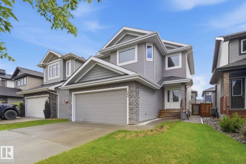 Contemporary two-story exterior featuring gray siding and stone accents - 33 Riviere Terrace, St. Albert, AB 