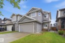 Contemporary two-story exterior featuring gray siding and stone accents - 33 Riviere Terrace, St. Albert, AB 