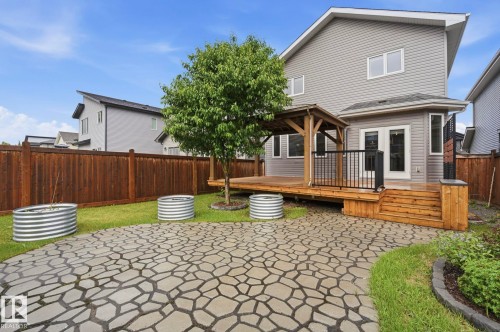 Expansive backyard featuring a custom paver patio and mature tree - 33 Riviere Terrace, St. Albert, AB 