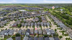 Expansive aerial perspective showcasing a residential development with numerous single-family homes and townhomes - 