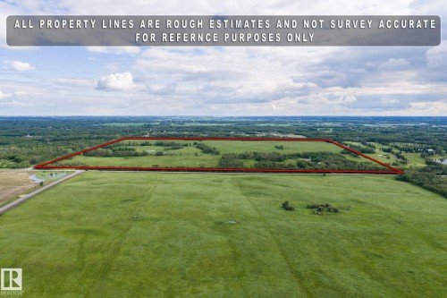 Expansive agricultural land featuring a verdant green field - 23327 Twp Rd 510, Rural Leduc County, AB 