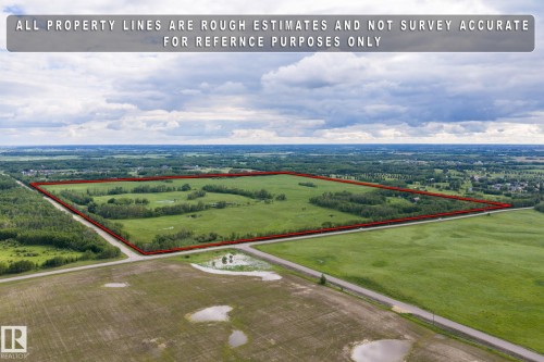 Expansive agricultural land featuring a mix of green pastures and wooded areas - 23327 Twp Rd 510, Rural Leduc County, AB 