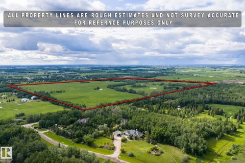 Expansive rural property featuring substantial acreage, a mix of open fields, and mature tree lines - 23327 Twp Rd 510, Rural Leduc County, AB 