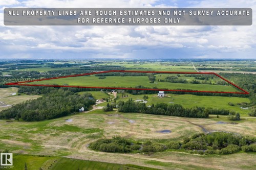 Expansive agricultural land featuring a mix of open fields and forested areas - 23327 Twp Rd 510, Rural Leduc County, AB 