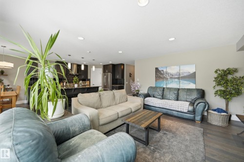 Open-concept living area featuring recessed lighting and dark wood-finish flooring - 5430 Edworthy Way, Edmonton, AB - Indoor Photo Showing Living Room
