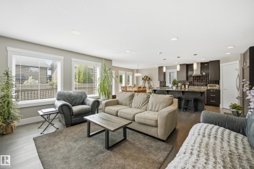 Open-concept living area with dark wood-finish flooring - 5430 Edworthy Way, Edmonton, AB - Indoor Photo Showing Living Room