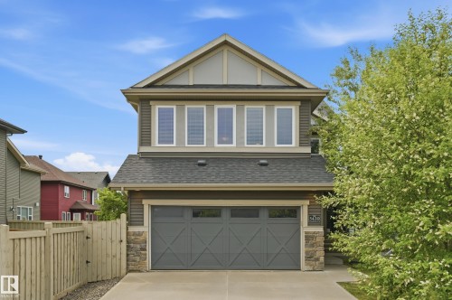 Contemporary two-story exterior with horizontal siding and stone accents - 5430 Edworthy Way, Edmonton, AB - Outdoor