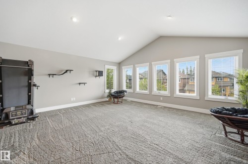 Spacious room featuring vaulted ceilings, recessed lighting, and light gray wall paint - 5430 Edworthy Way, Edmonton, AB - Indoor