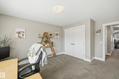 Neutral-toned room featuring light gray wall paint, white trim, and gray carpet flooring - 5430 Edworthy Way, Edmonton, AB - Indoor