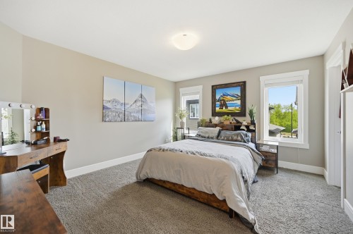 Spacious room featuring neutral carpeting, light neutral wall paint, and white trim - 5430 Edworthy Way, Edmonton, AB - Indoor Photo Showing Bedroom