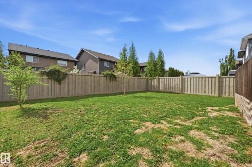 Expansive green space featuring a wood fence perimeter - 5430 Edworthy Way, Edmonton, AB - Outdoor