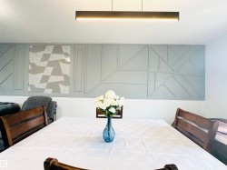 Accent wall featuring geometric paneling and a tiled insert - 