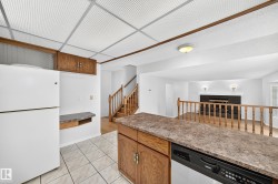 Kitchen area featuring white ceramic tile flooring and wood-finish cabinetry - 