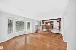 Bright living area featuring wood-finish flooring and a bay window - 
