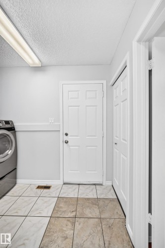 Light-toned ceramic tile flooring with contrasting sections - 9843 188 Street, Edmonton, AB 
