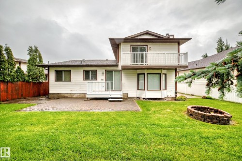 Rear exterior with a two-story design featuring a private upper balcony, ground-level deck, and a bay window - 9843 188 Street, Edmonton, AB 