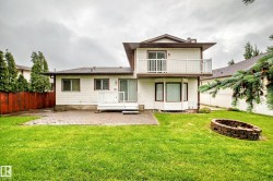 Rear exterior with a two-story design featuring a private upper balcony, ground-level deck, and a bay window - 