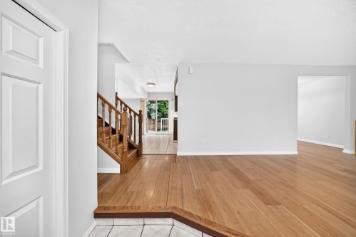 Warm wood-finish flooring extending from the entryway - 9843 188 Street, Edmonton, AB 