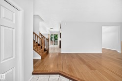 Warm wood-finish flooring extending from the entryway - 
