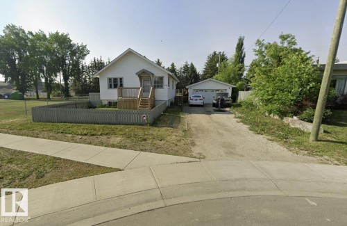 White-sided residence with an attached wooden front deck and stairs - 110 Jespersen Avenue, Spruce Grove, AB 
