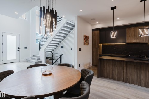Contemporary kitchen and dining area featuring light wood-finish flooring - 1313 Clement Crest, Edmonton, AB 