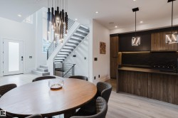 Contemporary kitchen and dining area featuring light wood-finish flooring - 