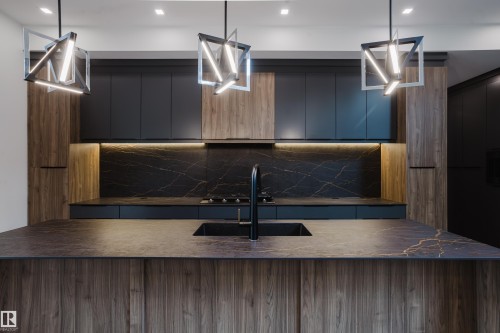 Kitchen island with integrated sink and matte black faucet - 1313 Clement Crest, Edmonton, AB 