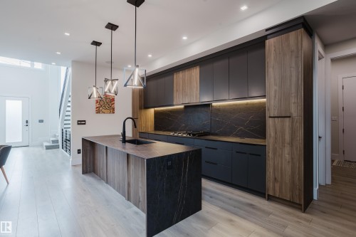 Contemporary kitchen featuring an integrated island with a waterfall edge - 1313 Clement Crest, Edmonton, AB 
