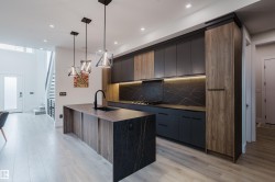 Contemporary kitchen featuring an integrated island with a waterfall edge - 