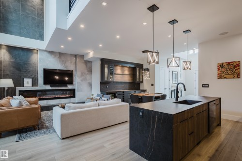 Open-concept living space with light wood-finish flooring - 1313 Clement Crest, Edmonton, AB 