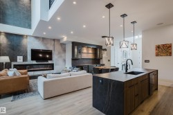 Open-concept living space with light wood-finish flooring - 