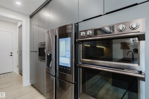 Stainless steel integrated appliances featuring a smart refrigerator and double wall oven - 1313 Clement Crest, Edmonton, AB 
