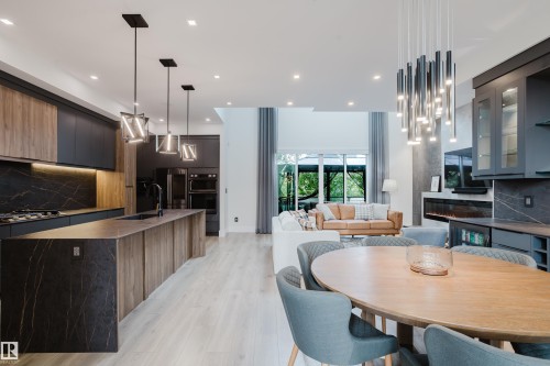 Open-concept living space with light wood-finish flooring - 1313 Clement Crest, Edmonton, AB 
