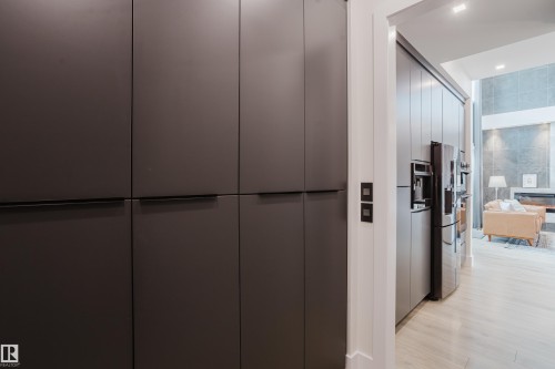 Integrated dark cabinetry with concealed handles - 1313 Clement Crest, Edmonton, AB 