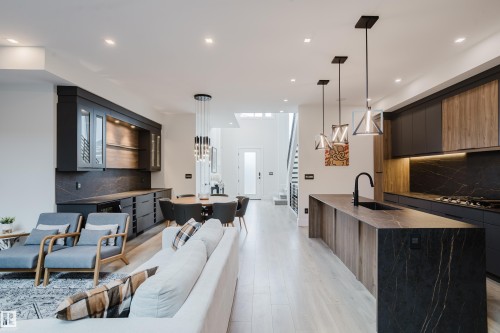 Open-concept living space featuring light wood-finish flooring - 1313 Clement Crest, Edmonton, AB 
