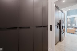 Integrated dark cabinetry with concealed handles - 
