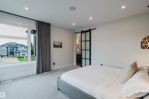Bedroom featuring recessed lighting, light-toned carpeting, and a large window with privacy drapery - 1313 Clement Crest, Edmonton, AB 