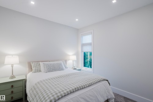 Bright interior room featuring a single window with roller shade, recessed ceiling lighting, and soft gray carpeting - 1313 Clement Crest, Edmonton, AB 