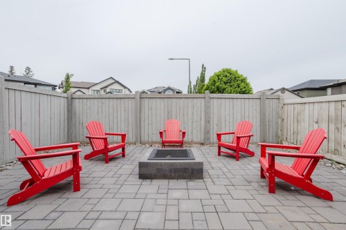 Paved patio featuring a built-in fire pit and full perimeter fencing - 1313 Clement Crest, Edmonton, AB 