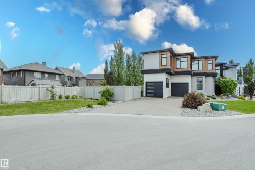 Contemporary architectural design featuring a multi-tone facade with wood-look and light-toned siding - 1313 Clement Crest, Edmonton, AB 