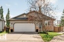 Single-family home featuring a concrete driveway, attached garage, and stone facade accents - 39 Wilkinson Place, Leduc, AB 