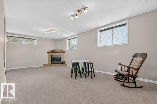 Spacious room with light neutral wall paint and light gray carpet flooring - 39 Wilkinson Place, Leduc, AB 