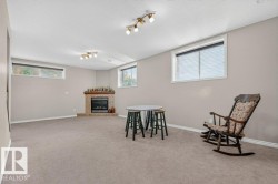Spacious room with light neutral wall paint and light gray carpet flooring - 
