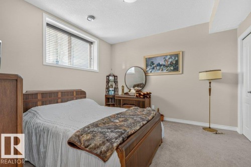 Bedroom featuring neutral-toned walls, carpet flooring, and white trim - 39 Wilkinson Place, Leduc, AB 