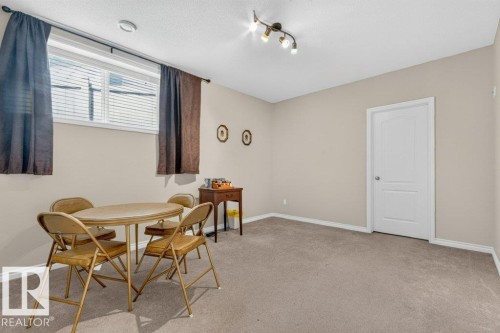 Spacious room featuring neutral carpet flooring and light-toned wall paint - 39 Wilkinson Place, Leduc, AB 