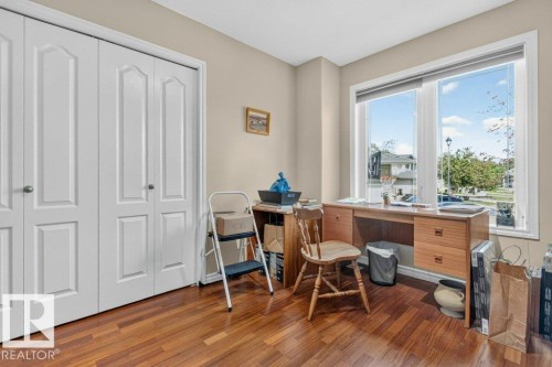 Interior room featuring wood-finish flooring, neutral wall paint, and white trim - 39 Wilkinson Place, Leduc, AB 