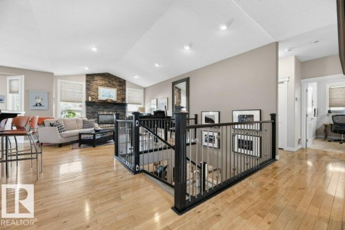 Open-concept living area with light wood-finish flooring, a vaulted ceiling, and recessed lighting - 5528 43 Street, Lamont, AB 