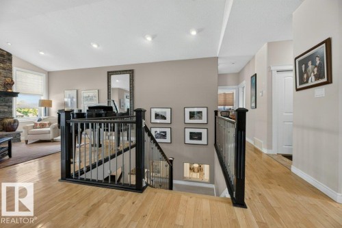 Hardwood flooring extending through a broad hallway and open-concept area - 5528 43 Street, Lamont, AB 