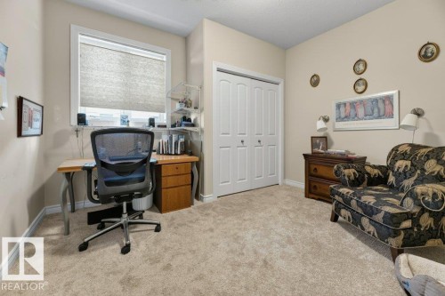 Plush carpeting throughout with a built-in closet featuring bi-fold doors - 5528 43 Street, Lamont, AB 